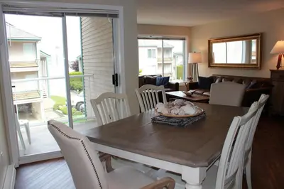 a dining room with a wooden table and chairs at Tanglewood 18 in Parksville