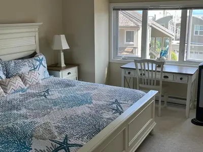 a bedroom with a bed and a desk and a window at Tanglewood 19 in Parksville