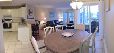 a kitchen and living room with a table and chairs at Tanglewood 19 in Parksville