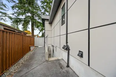 a hallway of a house with a fence at Peaceful 2BR Getaway with Fireplace & Parking Basement Suite in Abbotsford