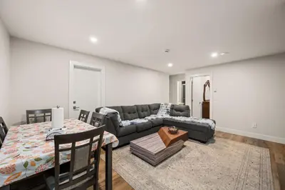 a living room with a couch and a table at Peaceful 2BR Getaway with Fireplace & Parking Basement Suite in Abbotsford