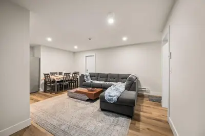 a living room with a couch and a table at Peaceful 2BR Getaway with Fireplace & Parking Basement Suite in Abbotsford