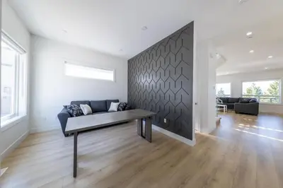 a living room with a couch and a table at Spacious 6BR Home with Terrace Views and Parking nearby parks golf and resorts in Chilliwack