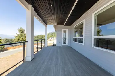 a porch of a home with a view of the mountains at Spacious 6BR Home with Terrace Views and Parking nearby parks golf and resorts in Chilliwack