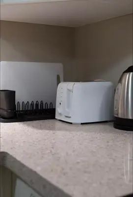 a white toaster oven sitting on top of a counter at Stylish Home in Van West Side Near YVR&DT in Vancouver