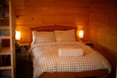 a bedroom with a bed with two lamps on it at Radium Cabins Centrally located in Radium Hot Springs BC in Radium Hot Springs