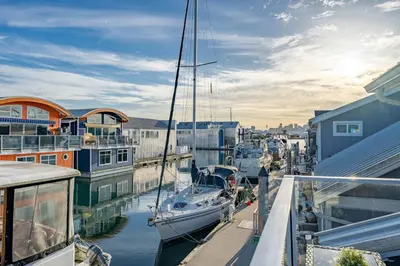 a boat docked in a marina with other boats at Cozy modern floating home next to Lonsdale Quay in North Vancouver