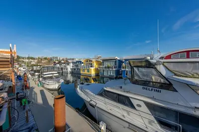 a bunch of boats are docked in a marina at Cozy modern floating home next to Lonsdale Quay in North Vancouver