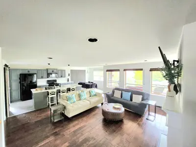a large living room with a couch and a table at Kelowna full level luxury-BIG white ski 35 mins in Kelowna