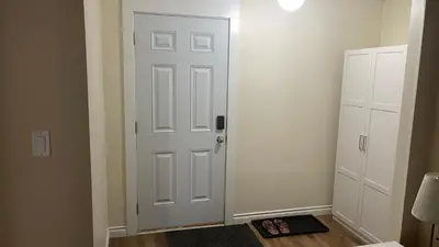 a white door in a room with a floor at Cozy Ground-Floor Room with Private Bath and Separate Entry in Delta