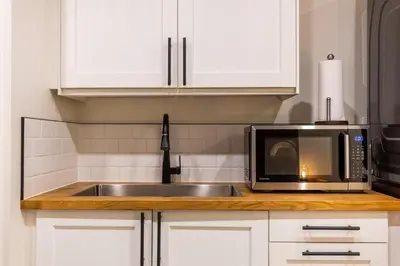 a kitchen with a sink and a microwave at Elkview by Fernie Central Reservations in Fernie