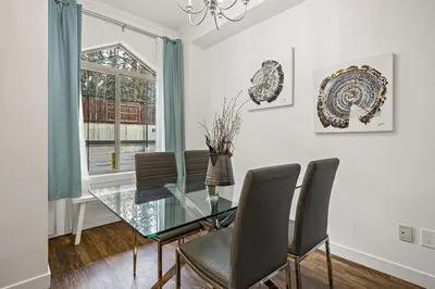 a dining room with a glass table and chairs at Marvellous Poolside Chalet - Pool & Hot Tub - Pets in Canmore