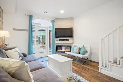 a living room with a couch and a tv at Marvellous Poolside Chalet - Pool & Hot Tub - Pets in Canmore