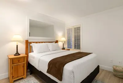 a white bedroom with a large bed and a window at Ski-In/Out | Upper Village | Free Parking in Whistler