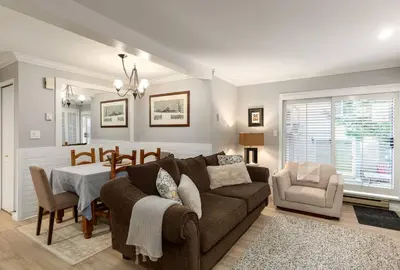 a living room with a couch and a table at Ski-In/Out | Upper Village | Free Parking in Whistler