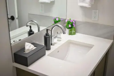 a bathroom counter with a sink and a mirror at Rockies Retreat Getaway Heated Pool &Hot Tub Gym in Dead Man's Flats
