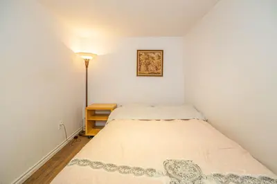 a small bedroom with a bed and a lamp at 2 BDRS at DT-Near 2 metros, Atwater Market, Concordia in Bélanger