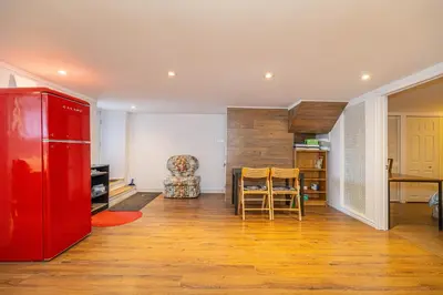 a kitchen with a red refrigerator and a table at 2 BDRS at DT-Near 2 metros, Atwater Market, Concordia in Bélanger