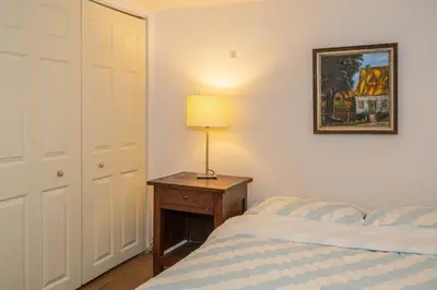 a bedroom with a bed and a lamp on a table at 2 BDRS at DT-Near 2 metros, Atwater Market, Concordia in Bélanger