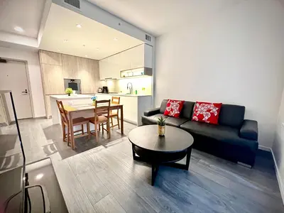 a living room with a couch and a table at Warm and Cozy 1B1B near Richmond center in Richmond