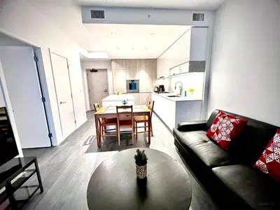 a living room with a couch and a table at Warm and Cozy 1B1B near Richmond center in Richmond