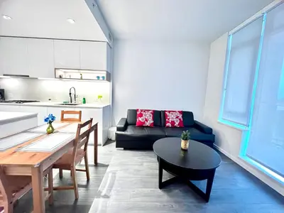a living room with a couch and a table at Warm and Cozy 1B1B near Richmond center in Richmond