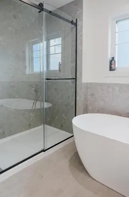 a bathroom with a glass shower and a tub at Brown Family Vacation Home in Leduc
