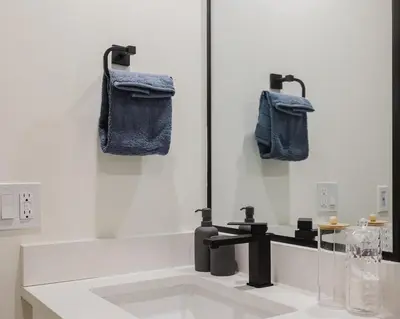a bathroom with a bath tub with a sink at Brown Family Vacation Home in Leduc