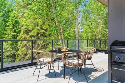 a patio with a table and chairs and a stove at Stylish 2BR Golden Getaway with BBQ and Stunning Views in Golden