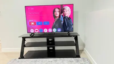 a flat screen tv sitting on top of a black stand at Zillion’s Bliss - Basement Suite in Calgary