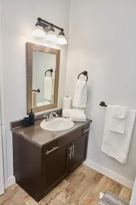 a bathroom with a sink and a mirror at Anukc in Prince George