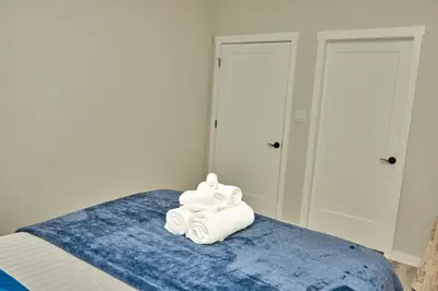 a pile of towels sitting on top of a bed at Anukc in Prince George