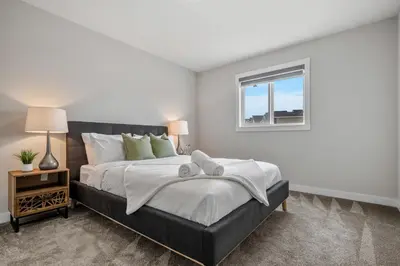 a bedroom with a large bed and a window at The Herron Rise Retreat in Calgary