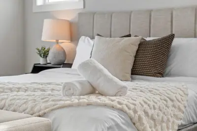 a bedroom with a bed with towels on it at The Herron Rise Retreat in Calgary