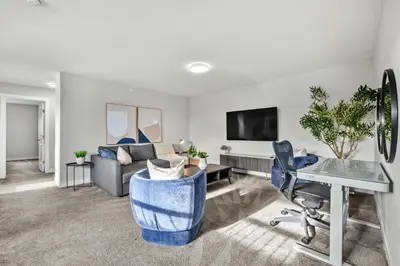 a living room with a couch and a table at The Herron Rise Retreat in Calgary