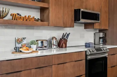a kitchen with a counter top with a microwave at 4BR Luxury Mountain Retreat Private HotTub Sleeps 17 in Canmore