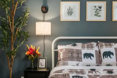 a bedroom with a bed and a blue wall at Urban Retreat Suits 2 Bedroom & Feature Packed in Calgary
