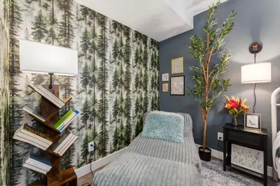 a bedroom with a bed and a tree mural at Urban Retreat Suits 2 Bedroom & Feature Packed in Calgary