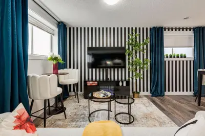 a living room with black and white stripes at Urban Retreat Suits 2 Bedroom & Feature Packed in Calgary
