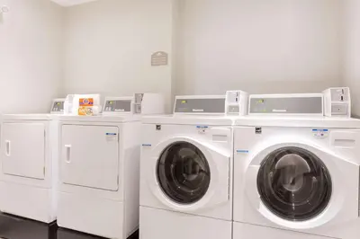 three washing machines and a washer and dryer in a room at Microtel Inn and Suites by Wyndham Kitimat in Kitimat