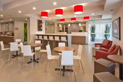 a restaurant with tables and chairs and a counter at Microtel Inn and Suites by Wyndham Kitimat in Kitimat