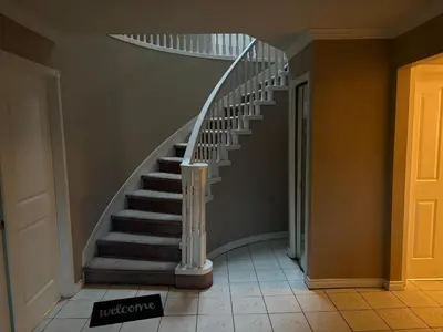 a staircase in a house with a spiral stair case at North Delta Guest House - Scott Rd & Rapid Transit - Airport 20 Min - Free Parking & Fast Wi-Fi in Delta