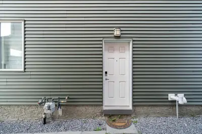 a door on the side of a house at Modern 1BR Suite Sleeps 3-4 in Near YYC Calgary Airport in Calgary