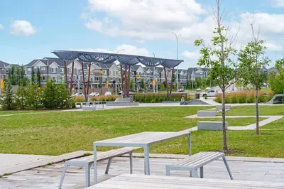 a park with benches and buildings in the background at Modern 1BR Suite Sleeps 3-4 in Near YYC Calgary Airport in Calgary
