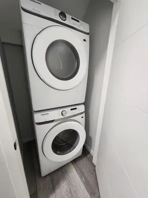 a washer and dryer in a small room at Stylish furnished 2bedroom suite near YYC Airport in Calgary