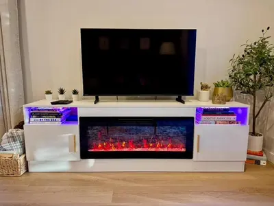 a white entertainment center with a tv on top at Island Coastal Retreat in Qualicum Beach