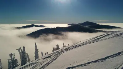 a view of a snow covered mountain with clouds at NEW Midtown Rossland Studio Apartment in Rossland