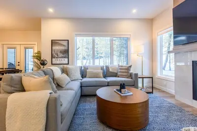a living room with a couch and a coffee table at Four Bears Chalet by Fernie Central Reservations in Fernie