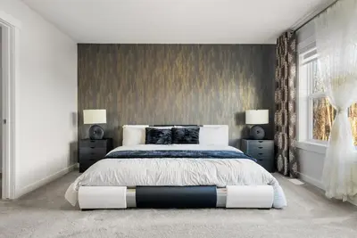 a bedroom with a large bed and a window at The Copperleaf Luxury Retreat with Hot tub in Calgary