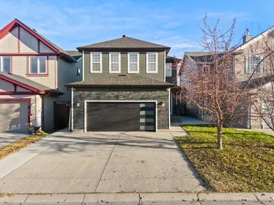 a house with a large garage in the driveway at The Copperleaf Luxury Retreat with Hot tub in Calgary